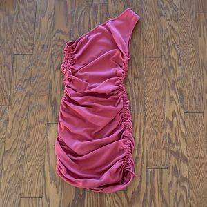 A short Coral one shoulder dress with full length scrunch on both sides